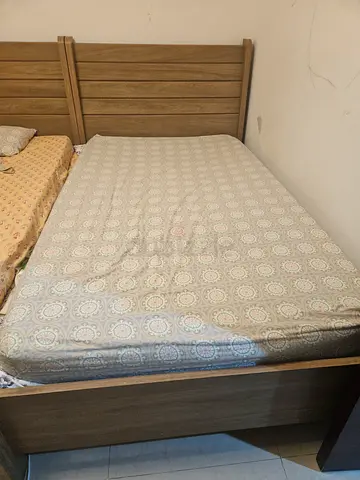 Single bed with mattress and bed sheets