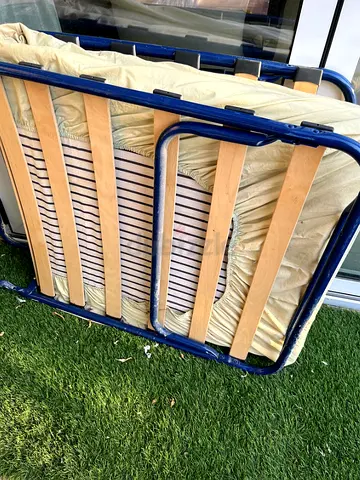 Folding bed with mattress