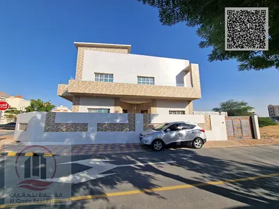 Corner villa for sale in Ajman, Al Muwaihat area. It features 5 master bedrooms, a majlis, a living room, and a maid's room. Freehold ownership availa