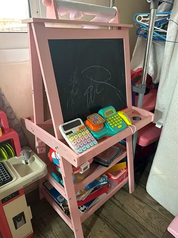 My pink wooden kids easel with chalkboard and pretend-play kitchen accessories
