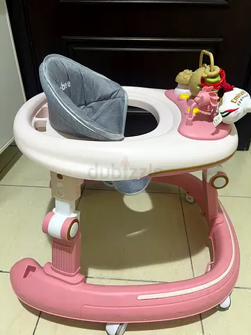 Pink baby walker with padded seat and toy tray - used