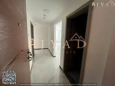 For rent: 2 bedrooms hall apartment in Al Nuaimiya 3 Ajman, first occupancy, near Dubai Islamic Bank, 2 bathrooms, central AC, free parking
