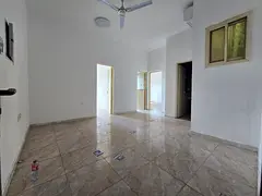 Two bedrooms and a living room for annual rent in Al Rawda 3, Ajman. Features include a balcony, exc