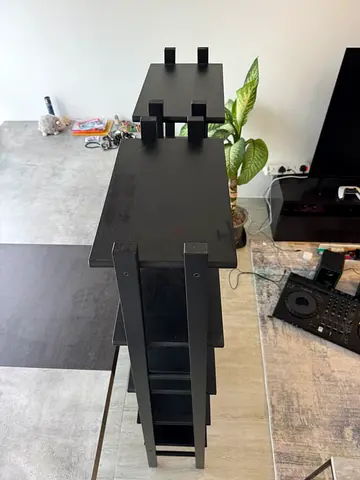 Tall black wooden tower shelf — display/plant stand