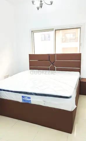 Brown upholstered bed frame with mattress and headboard