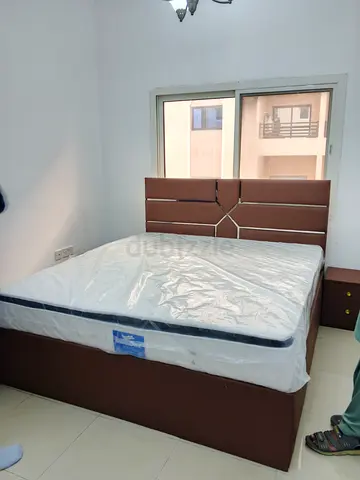 Brown upholstered bed frame with mattress and headboard