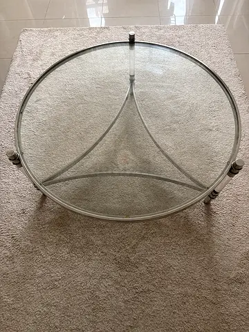 Round glass coffee table with silver metal base