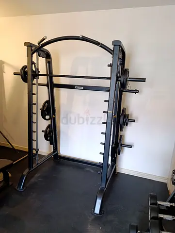 Smith machine (squat rack) with barbell and weight plates - used