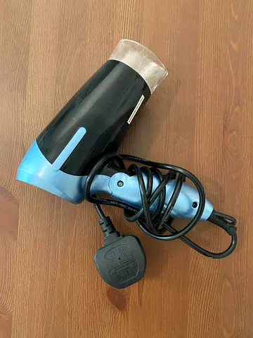 Compact blue travel hair dryer - working
