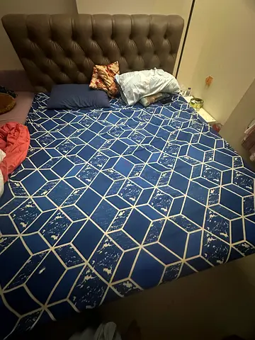 Upholstered bed frame with tufted headboard and mattress