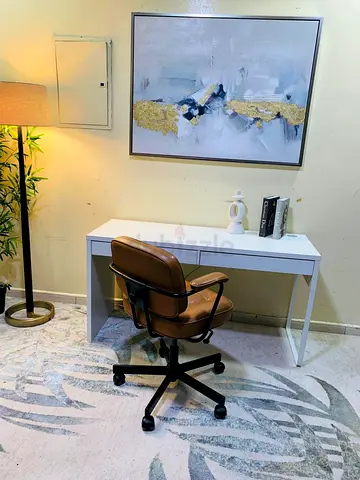 White study desk with brown swivel office chair - used