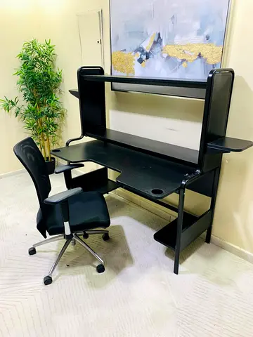 Black computer desk with hutch and ergonomic swivel chair