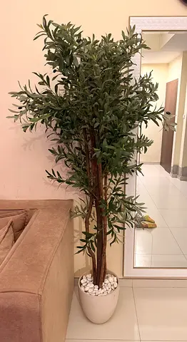 Tall artificial potted tree (olive-style) with white pot and decorative pebbles