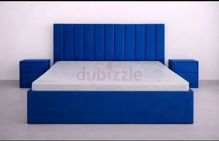 Blue upholstered bed frame with matching nightstands