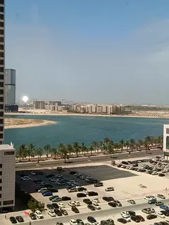 For rent in Al Khan: 2BR + hall with direct lake view, 2 baths, central AC, prime location near the