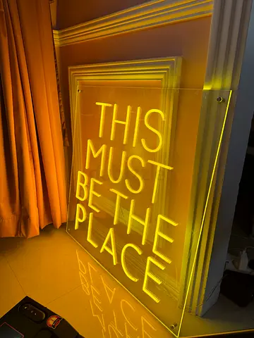 Warm-toned neon light in a soft orange/yellow glow.
