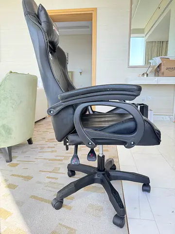 Black ergonomic high-back office chair with armrests and wheels