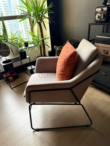 Modern light-grey lounge armchair with black metal frame