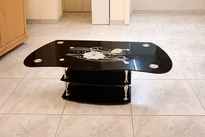 My black glass 2-tier coffee table with floral design