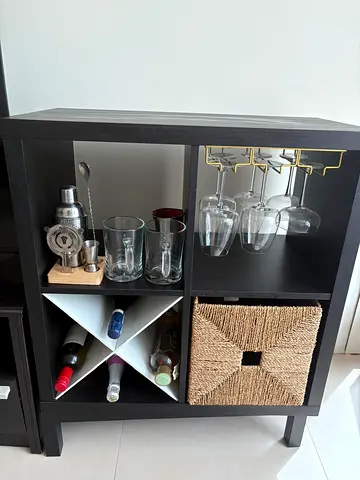 Small dark wood bar cabinet with wine rack and glass holders