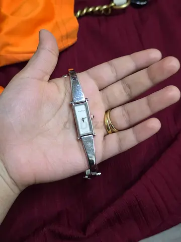 My silver bangle women’s gucci watch — slim rectangular face, good condition