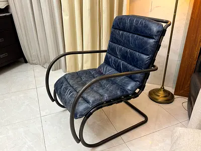Navy Blue genuine leather rocking chair with a bent metal frame