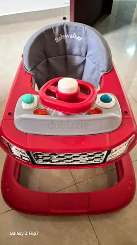 Red baby walker with activity tray - good condition