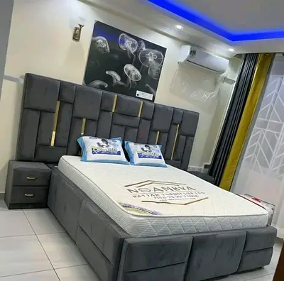 My grey upholstered storage bed with padded headboard and attached nightstands