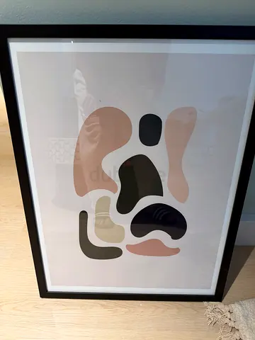 Framed abstract modern art print in black frame