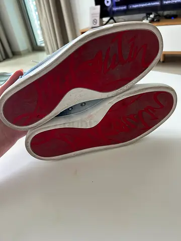 Womens white low-top sneakers with red soles - used