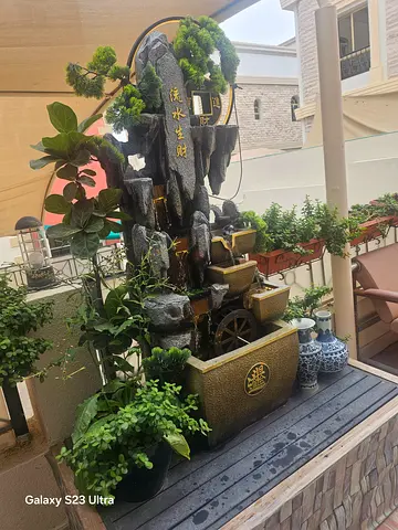 Large Chinese-style outdoor water fountain with planters