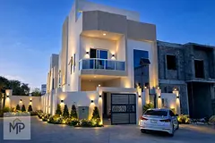 A villa for sale in Al Helio 2, Ajman, with all registration, ownership, electricity, and water fees