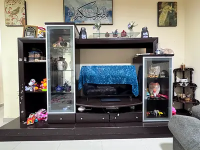 My dark wood entertainment center with glass display cabinets.
