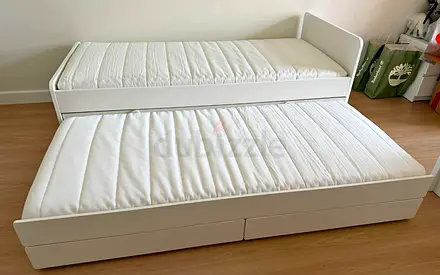 Ikea single bed with mattress underneath storage drawers