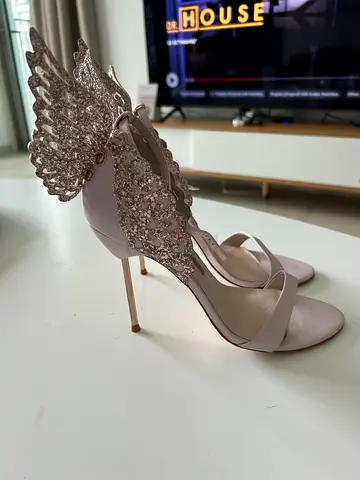 Blush pink stiletto sandals with crystal wing detail