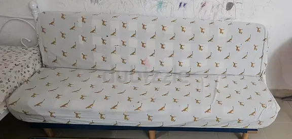 Futon sofa bed with giraffe-print cover