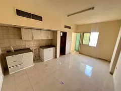 Studio apartment for annual rent in Al Rawda, Ajman. Features a balcony, spacious area, central air
