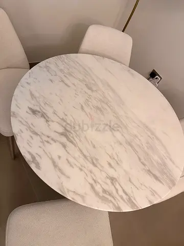 Round marble-top dining table with 4 chairs