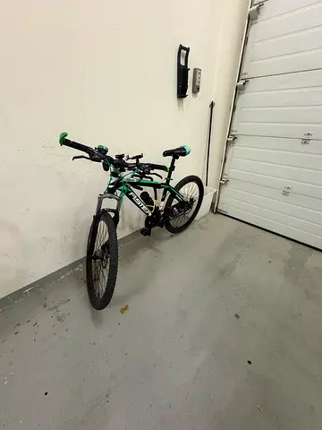 My green/black mountain bike with front suspension - good condition