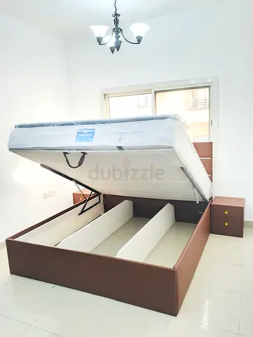 Brown hydraulic lift storage bed with mattress