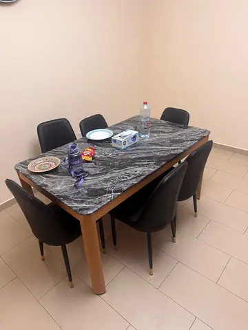 dining table with marble top and 6 black chairs