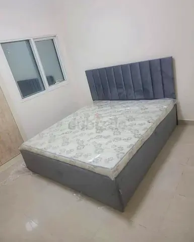Grey upholstered double bed with mattress (good condition)