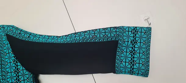 Teal patterned long-sleeve womens top.