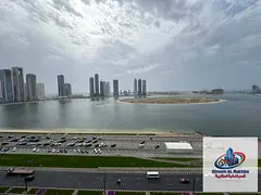 For annual rent in Sharjah, Al Khan area: a three-bedroom apartment with a living room, sea view, ma