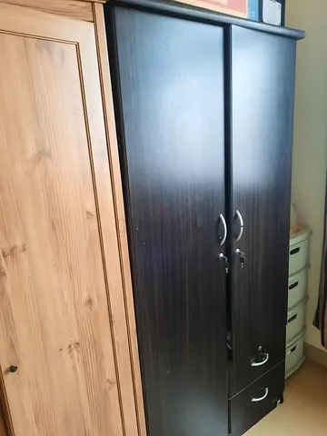 Im selling two tall wardrobes (dark brown  light wood) — used
