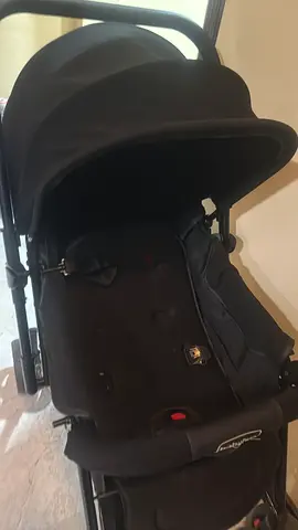 Gently used black pram-style stroller with bassinet