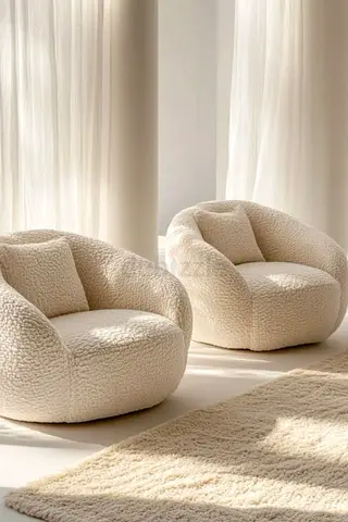 Pair of cream bouclé lounge armchairs