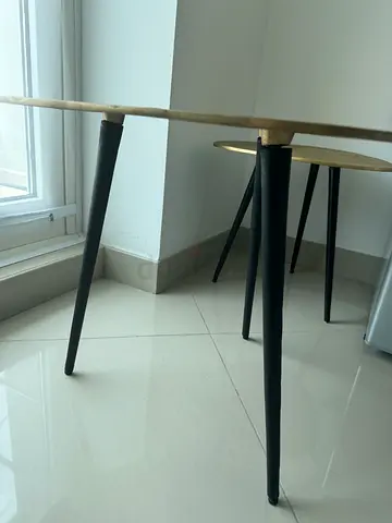 Set of 2 round nesting side tables - gold top, black legs