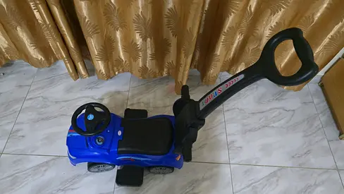 Blue toddler push ride-on car with parent handle, good condition