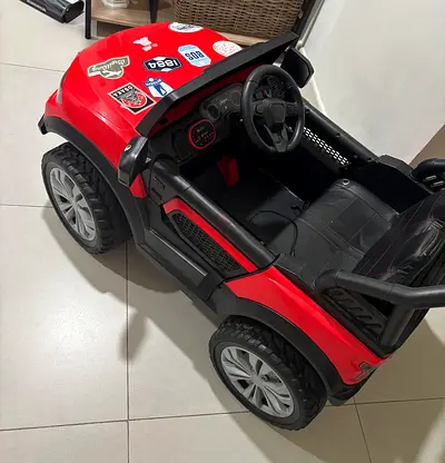 Red battery-powered kids ride-on car — used, working
